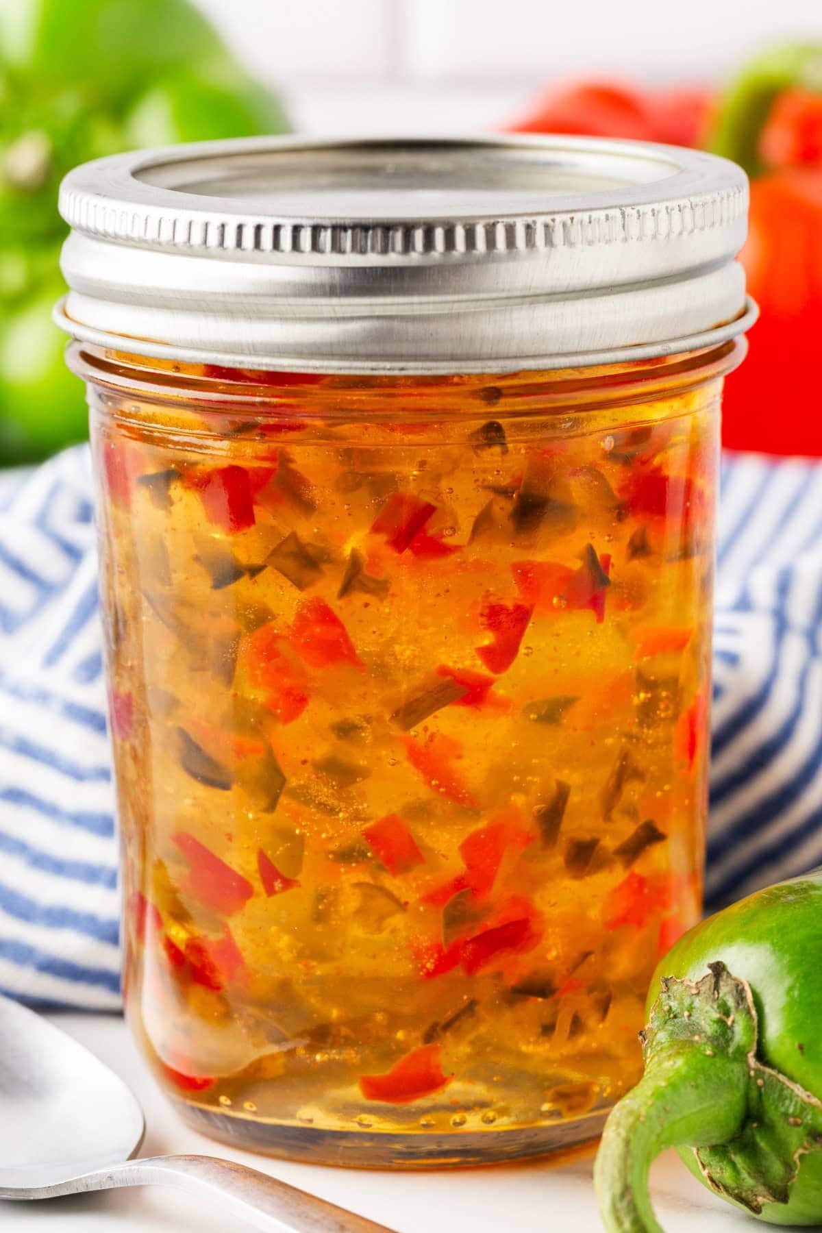Red and green pepper jelly in small jar.