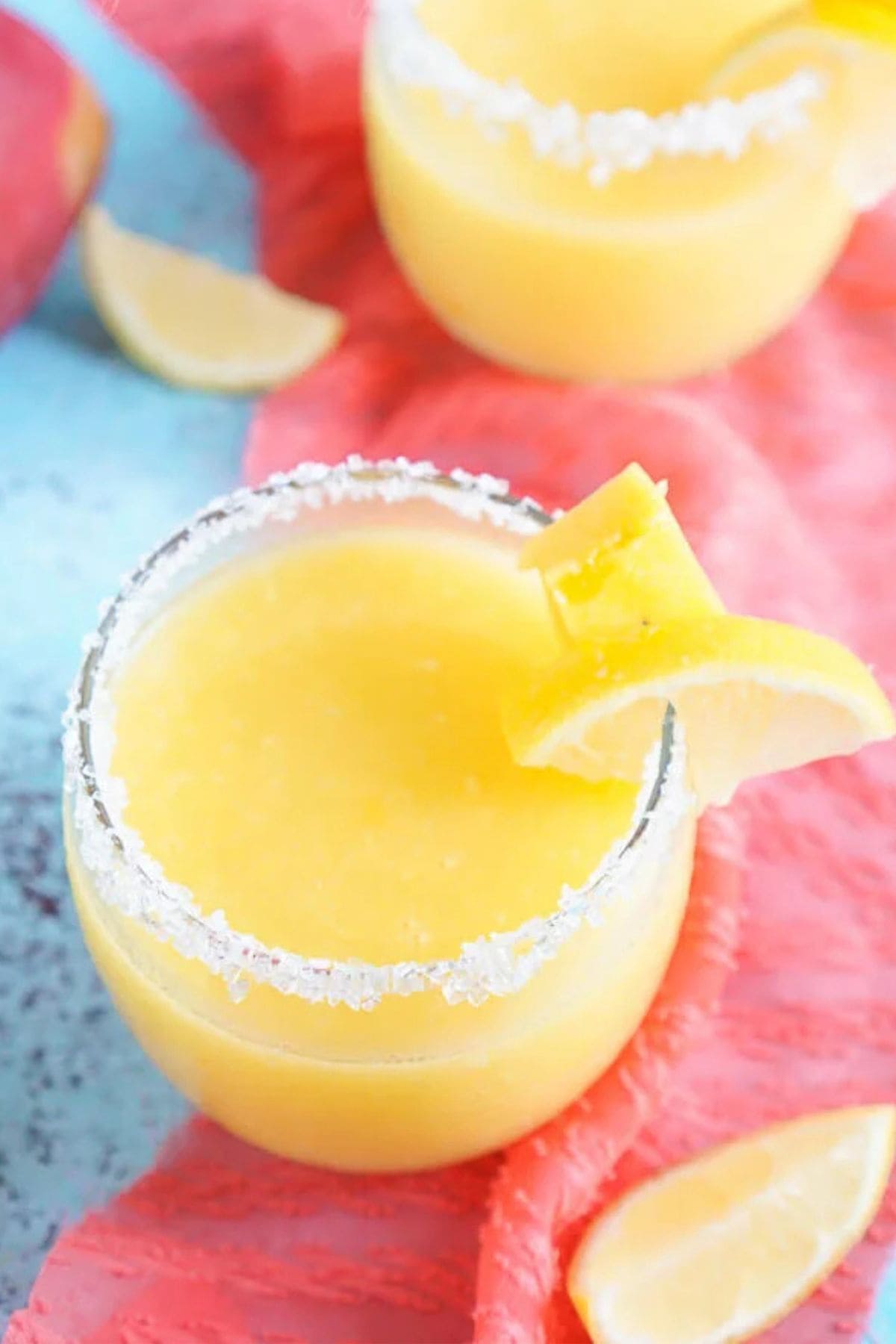Get outside and enjoy the day with these 50 Picnic Basket Essentials. There is something for everyone to pack the perfect picnic and enjoy family time and the great outdoors. Glass full of mango lemonade.