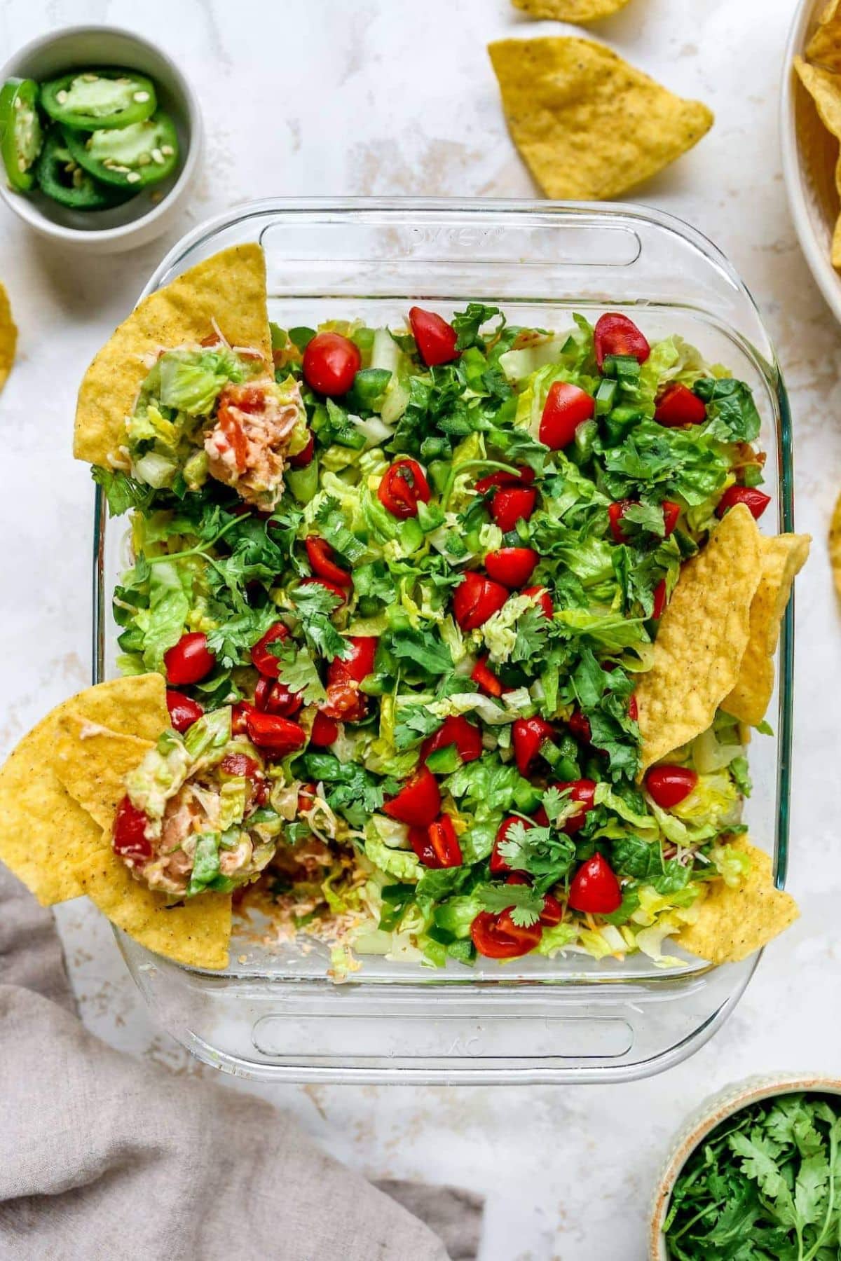 Baking dish full of 7 layer dip.