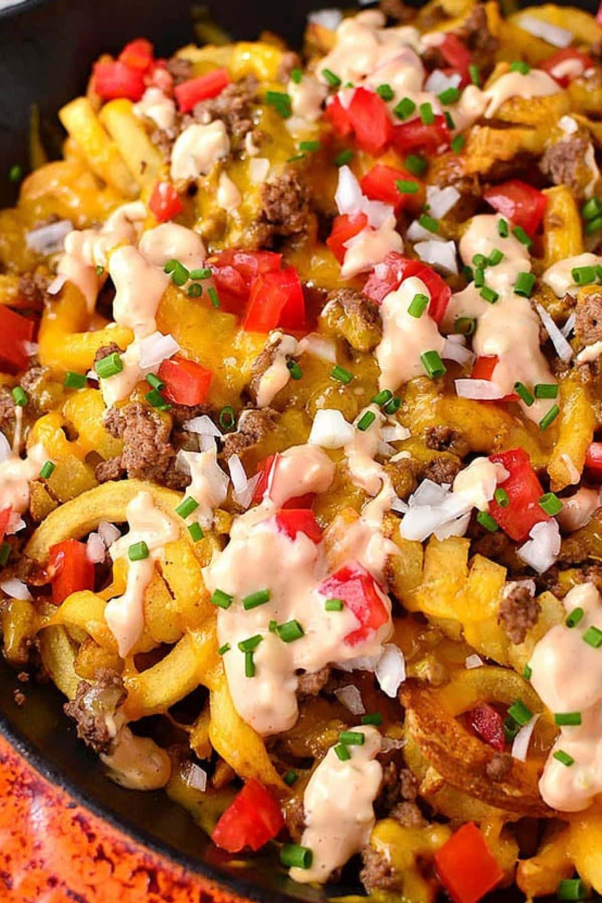 Cheeseburger fries in a skillet.