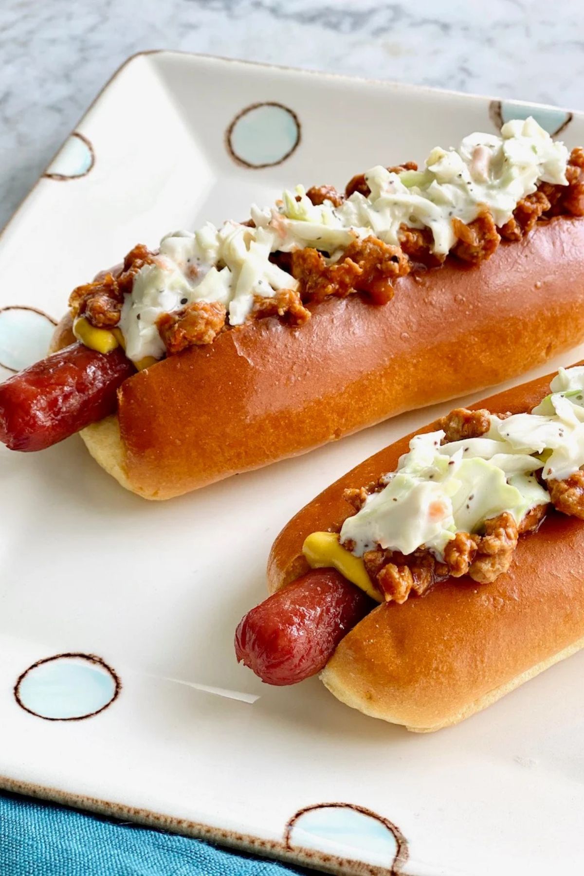 Chili dogs on a plate.