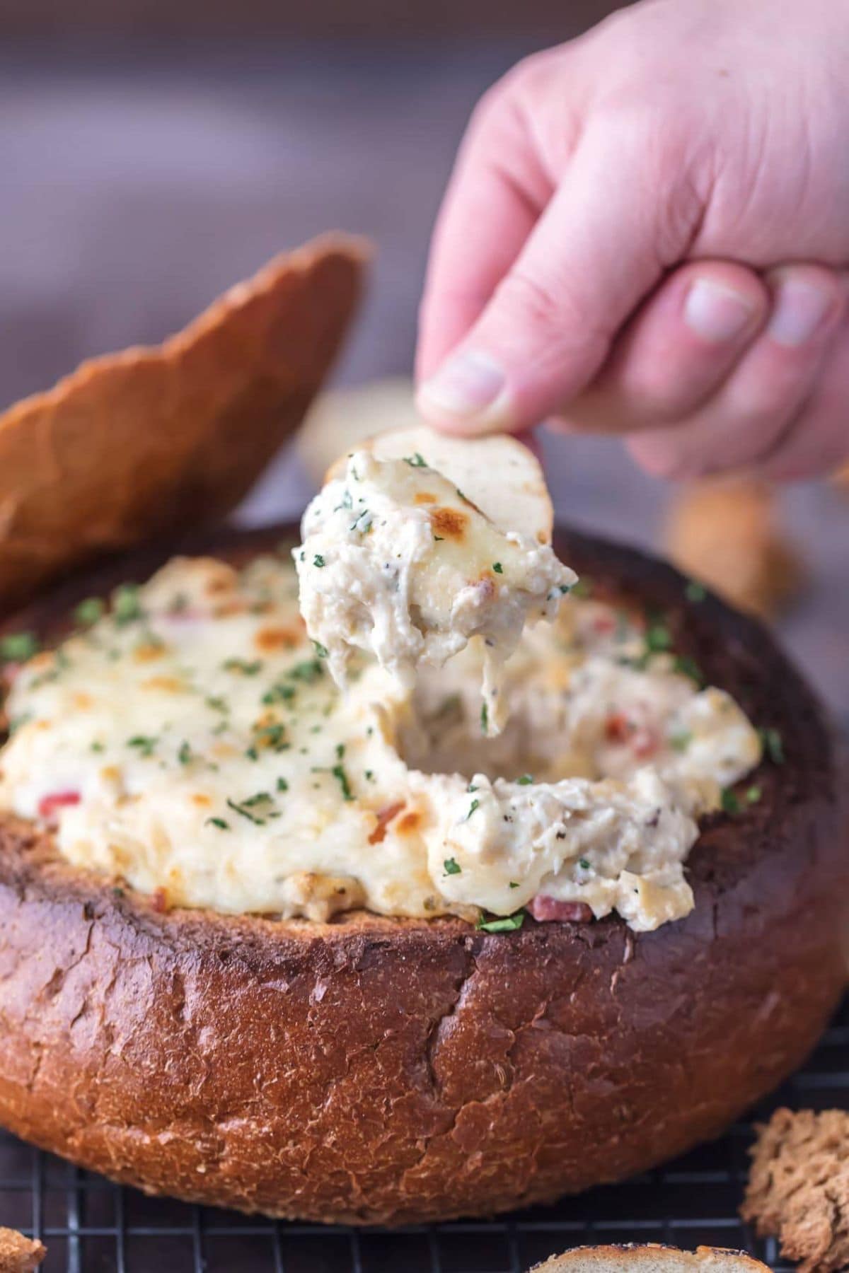 Chip scooping up dip.
