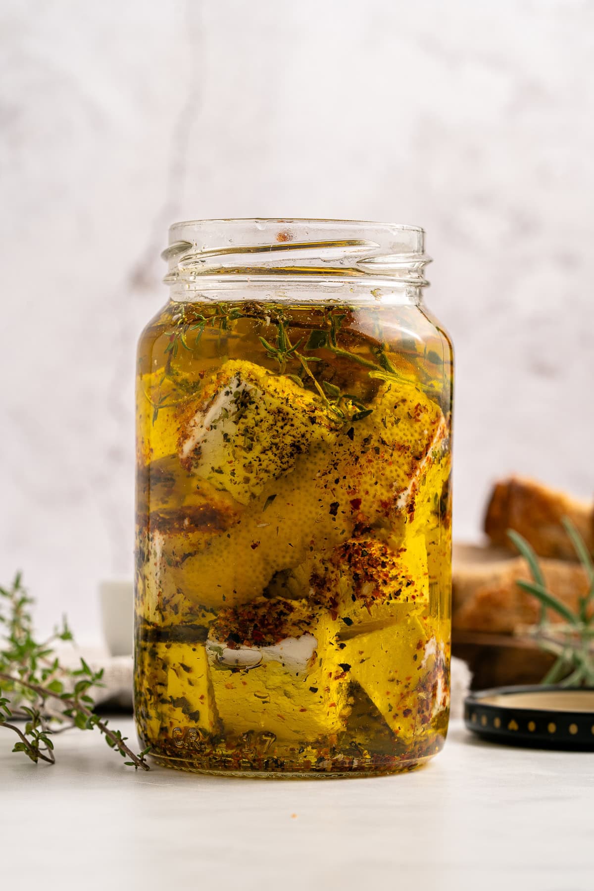 Marinated Feta is a great appetizer on its own or added to a charcuterie or Mediterranean platter. It is also amazing with a summer salad or Greek salad. Marinated feta in a jar.