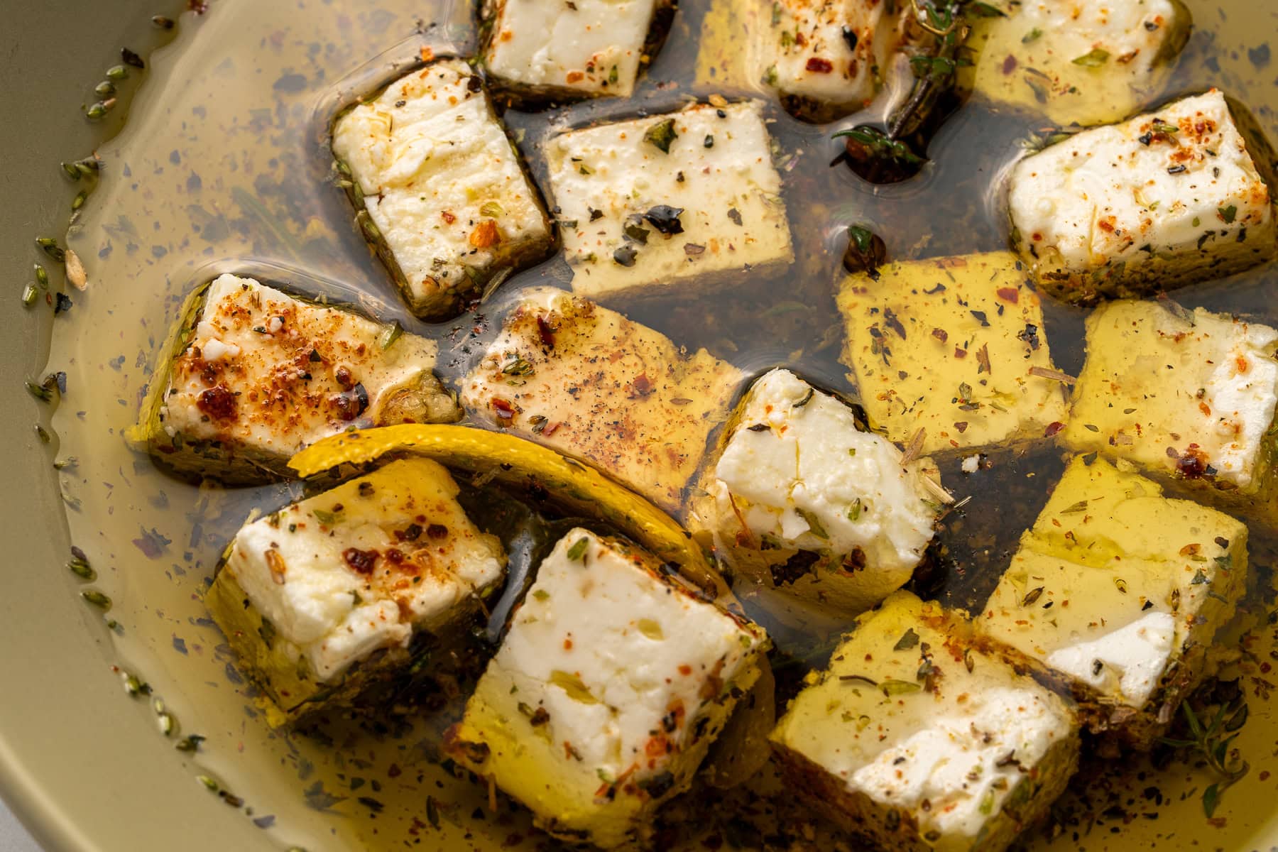 Marinated Feta is a great appetizer on its own or added to a charcuterie or Mediterranean platter. It is also amazing with a summer salad or Greek salad. Served marinated feta.