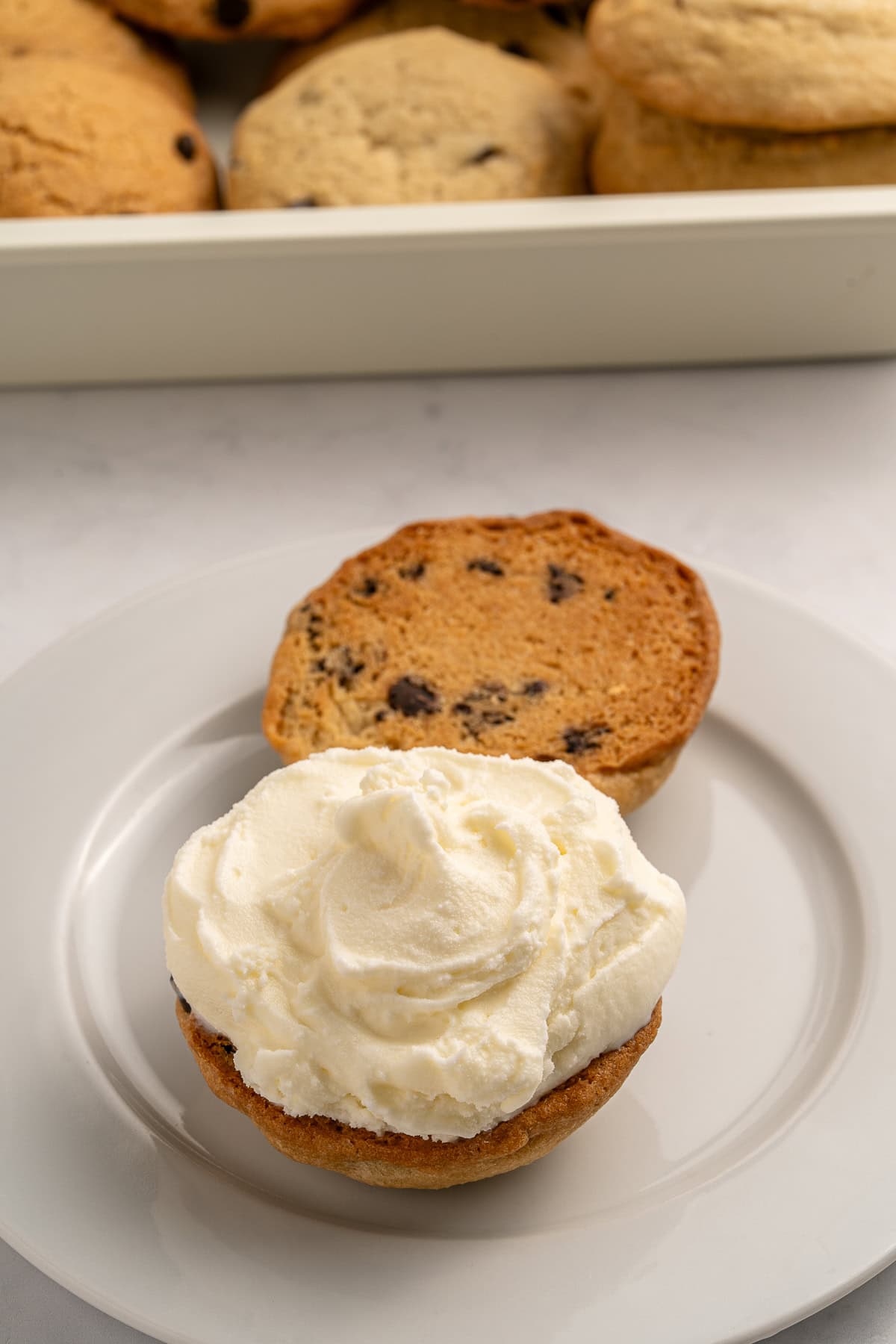 Make summer even more fun with these Cookie Ice Cream Sandwiches. These are a great make-ahead treat that is ready and waiting for you in the freezer for any time of the day. Assembling the ice cream sandwich.