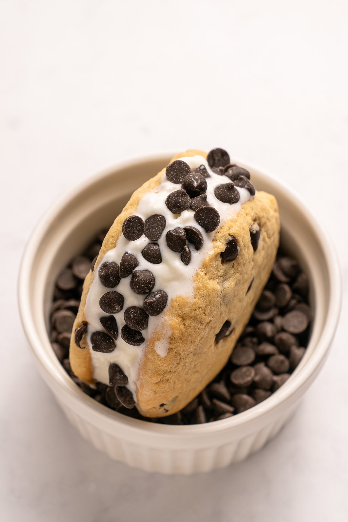 Make summer even more fun with these Cookie Ice Cream Sandwiches. These are a great make-ahead treat that is ready and waiting for you in the freezer for any time of the day. Coating the sides with mini chocolate chips.