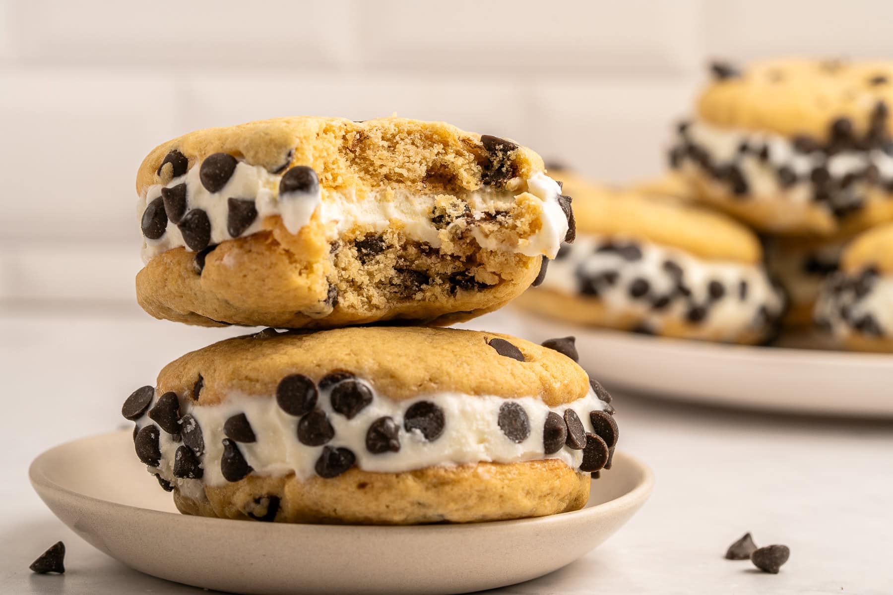 Make summer even more fun with these Cookie Ice Cream Sandwiches. These are a great make-ahead treat that is ready and waiting for you in the freezer for any time of the day. Bitten cookie ice cream sandwich.