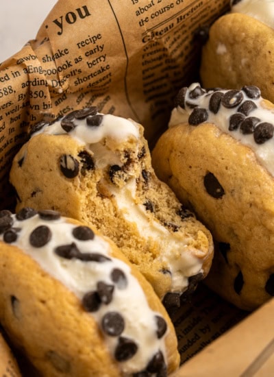 One cookie ice cream sandwich with a bite taken.