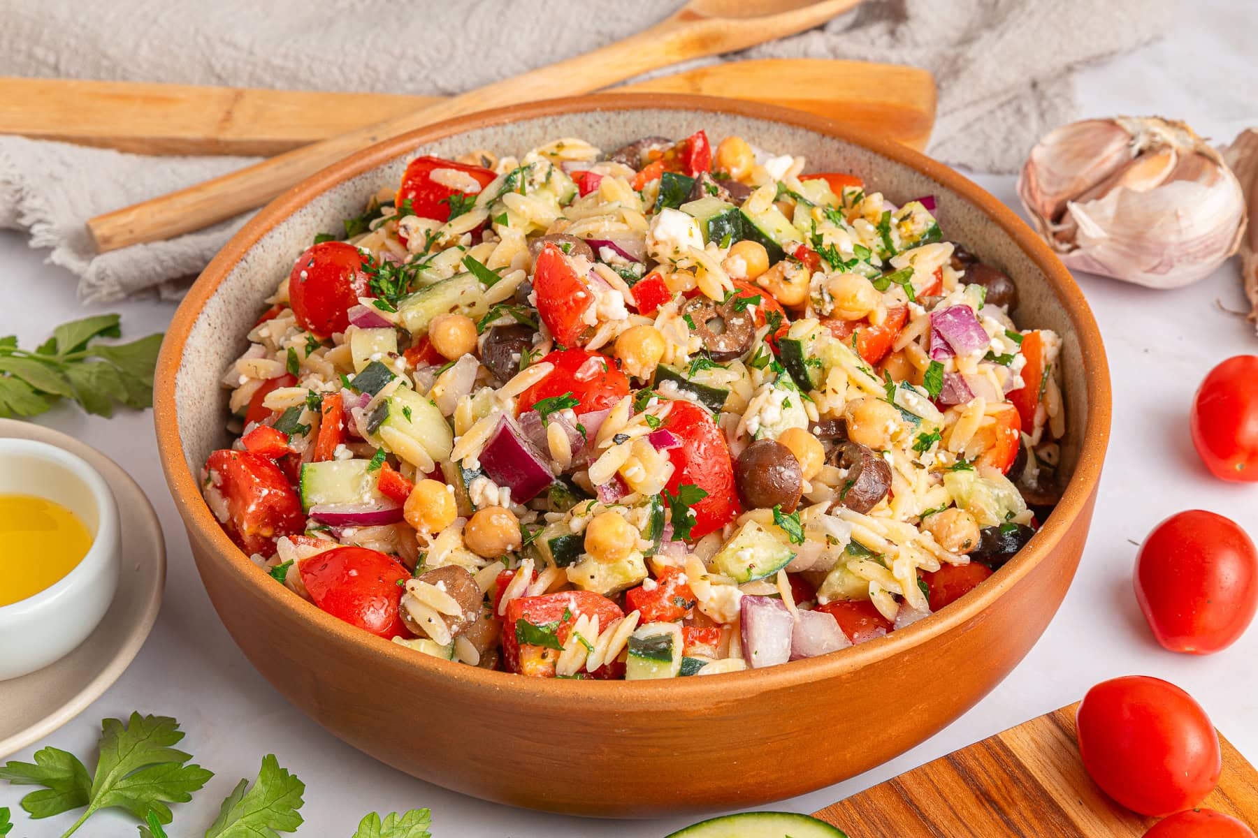 Another winner of a summer salad is this Greek Orzo Pasta Salad. It is easily portable, making it great for a picnic, BBQ or any gathering. It is hearty and healthy and full of flavors! Served greek orzo salad.