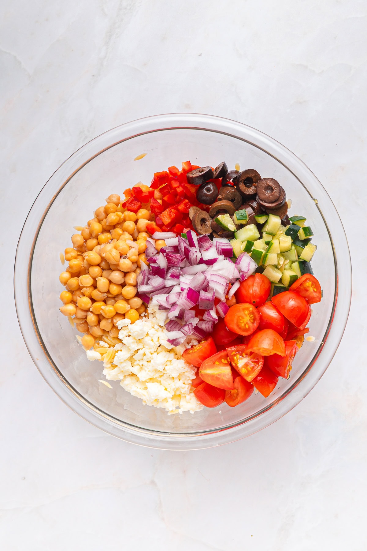 Another winner of a summer salad is this Greek Orzo Pasta Salad. It is easily portable, making it great for a picnic, BBQ or any gathering. It is hearty and healthy and full of flavors! Greek orzo pasta salad ingredients.