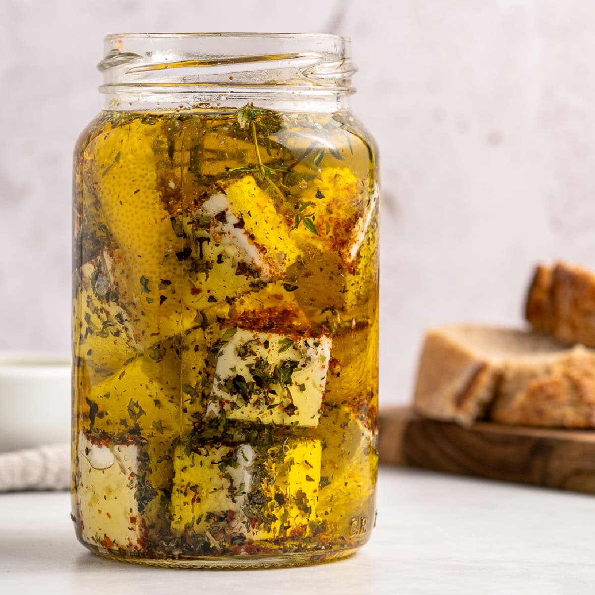 Marinated Feta is a great appetizer on its own or added to a charcuterie or Mediterranean platter. It is also amazing with a summer salad or Greek salad. Jar of Marinated Feta.