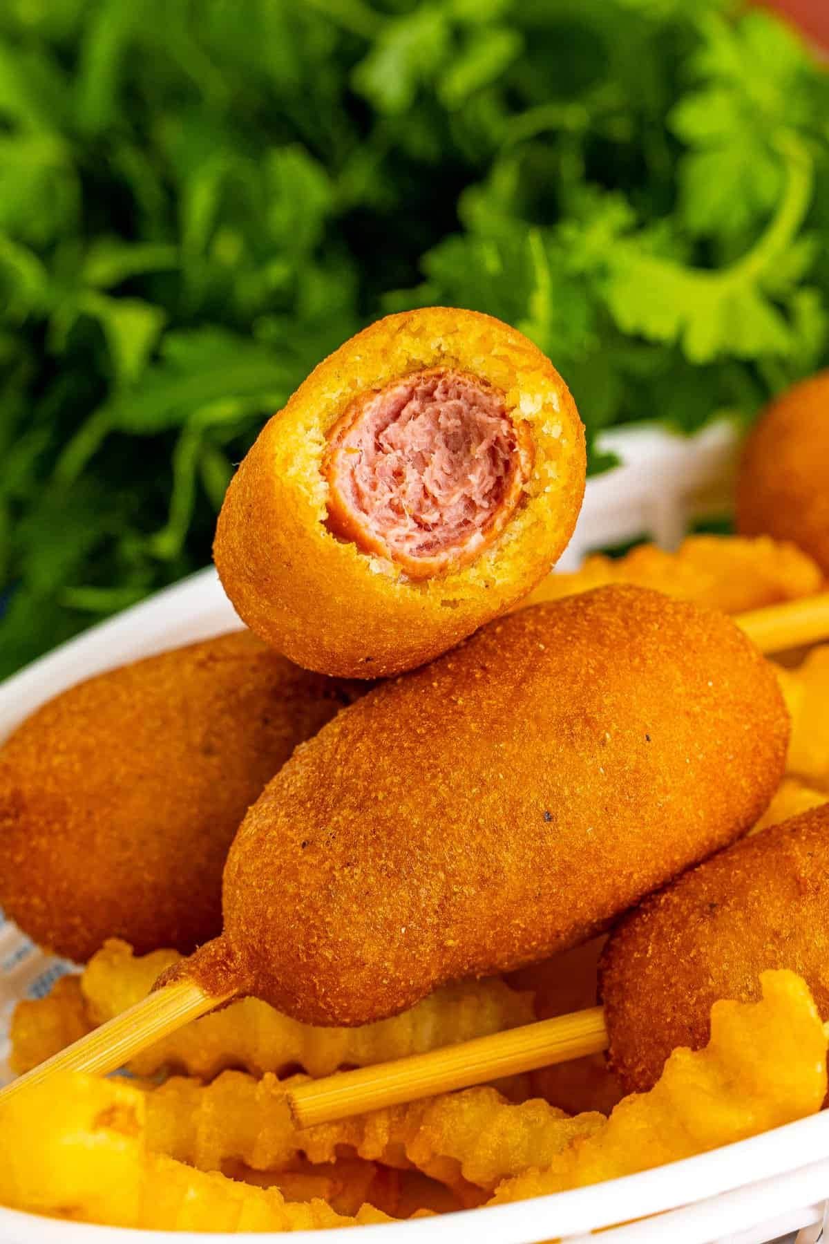 Mini corn dogs on a plate.