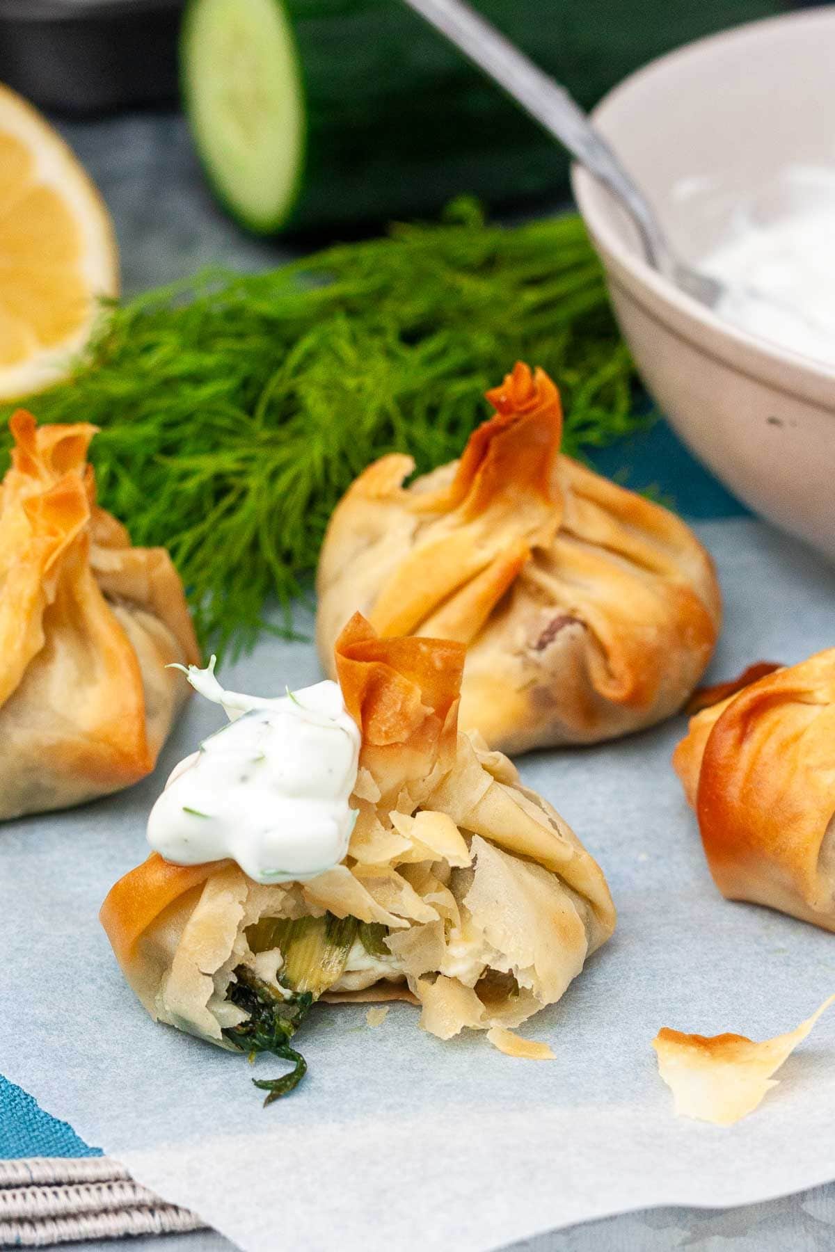 Phyllo full of spinach on a parchment paper.