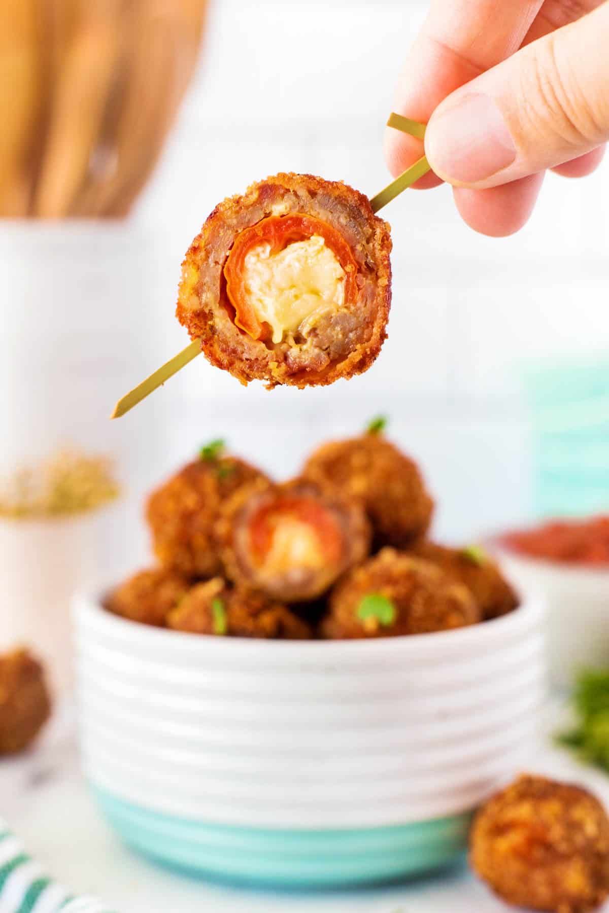 Stuffed meatball on toothpick.