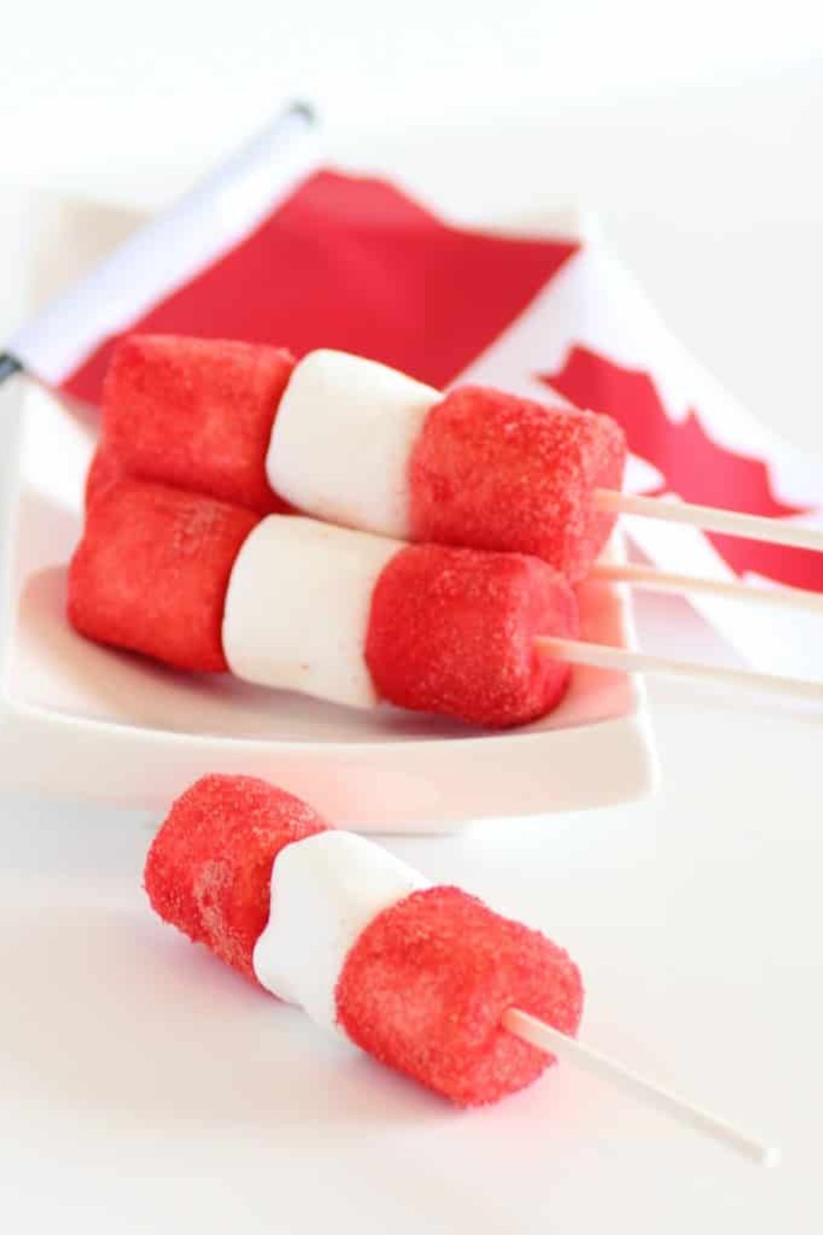 These 12 Canada Day Recipes are sure to please everyone at all your celebrations. Everyone will be diving in to enjoy all of these festive recipes. Red and white pops on plate.