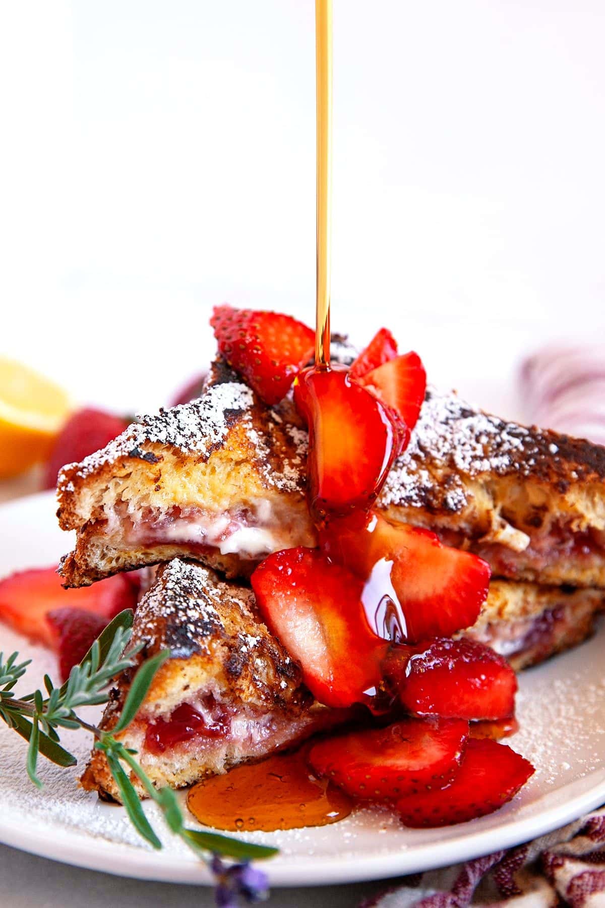 These 12 Canada Day Recipes are sure to please everyone at all your celebrations. Everyone will be diving in to enjoy all of these festive recipes. French toast on a plate.