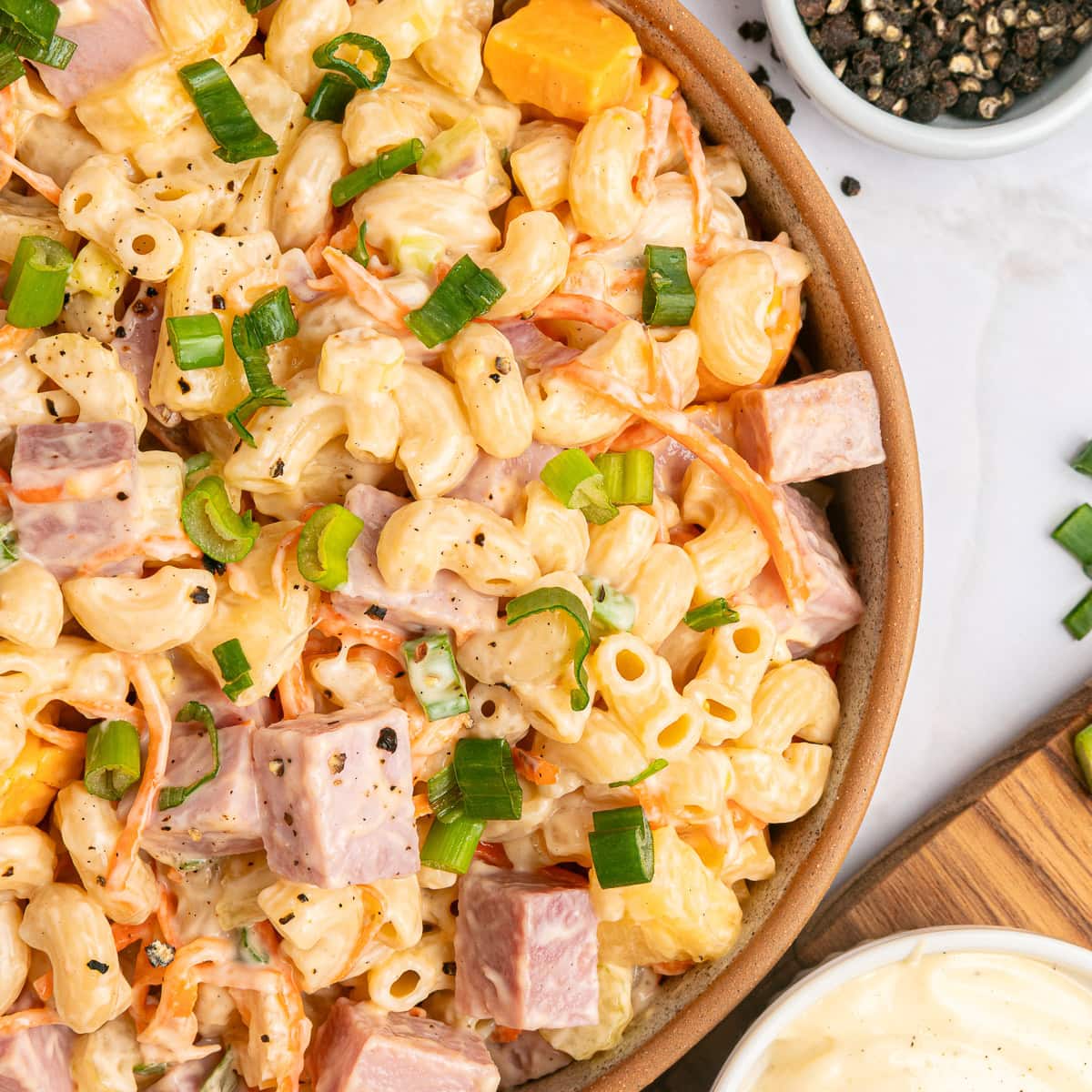 This Hawaiian Macaroni Salad is easy to pull together for a BBQ, gathering, picnic or even a lunchbox. It is inspired by a mouthwatering Hawaiian pizza. Overhead close-up of Hawaiian Macaroni Salad.