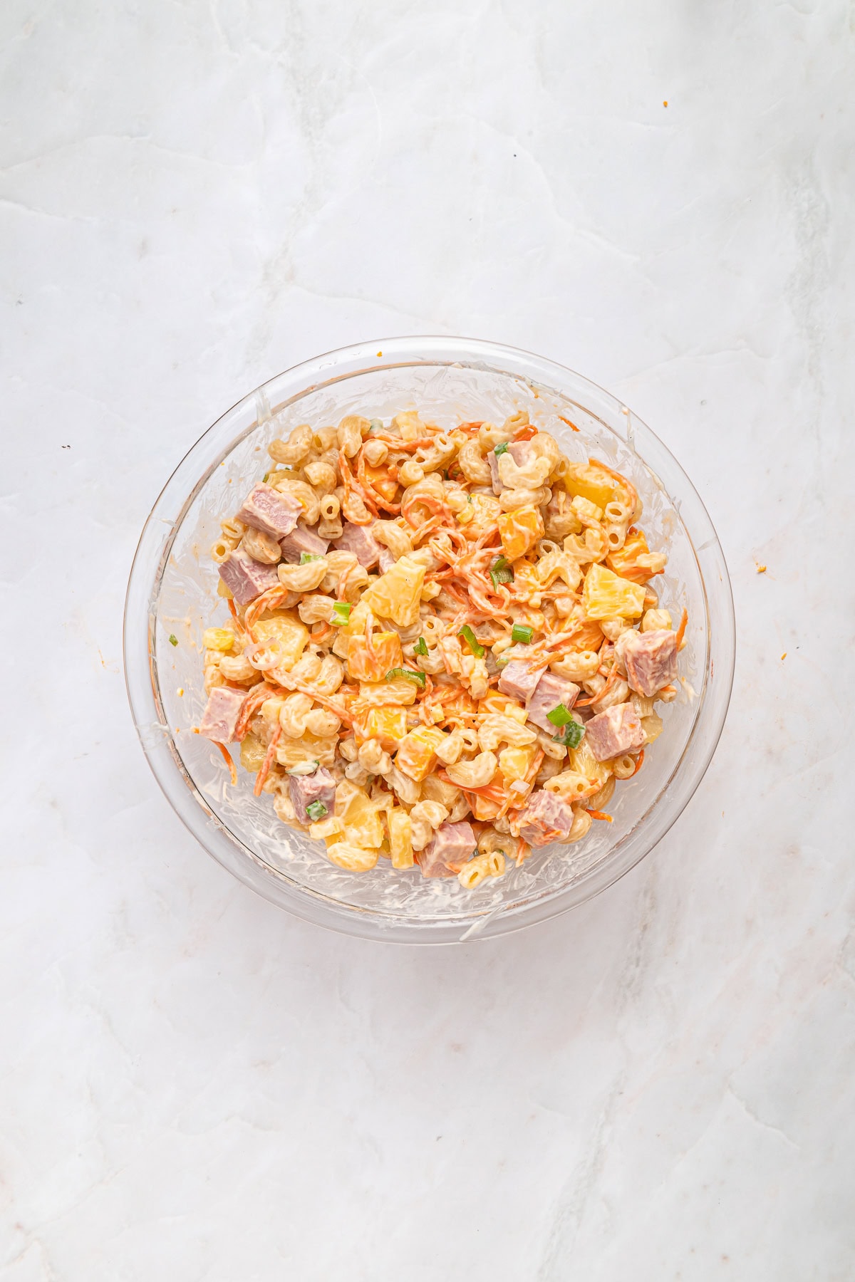This Hawaiian Macaroni Salad is easy to pull together for a BBQ, gathering, picnic or even a lunchbox. It is inspired by a mouthwatering Hawaiian pizza. The salad is mixed and ready.