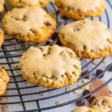 Iced Oatmeal Cookies on a cooling rack.