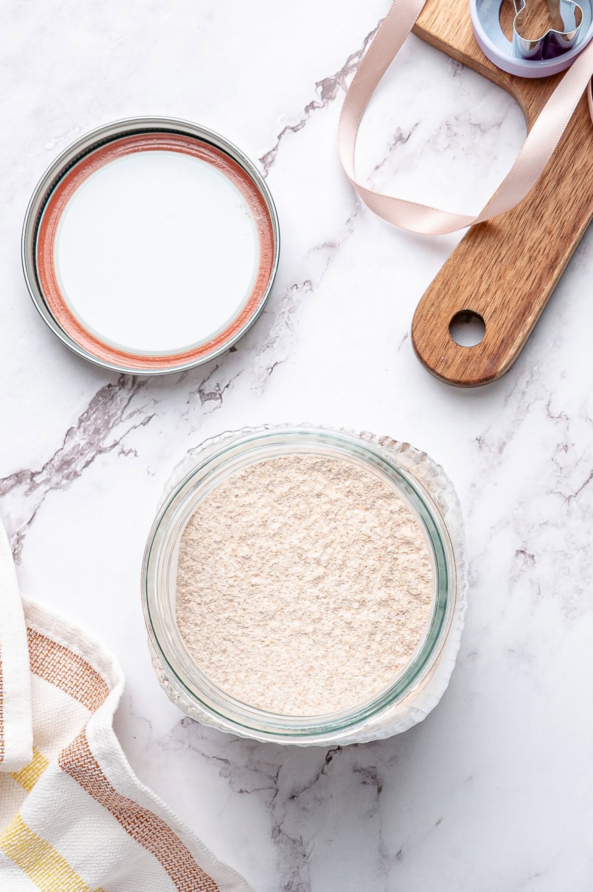 Whole wheat flour added to a jar. 