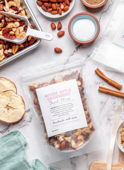 Trail mix bag lying down with ingredients around it.