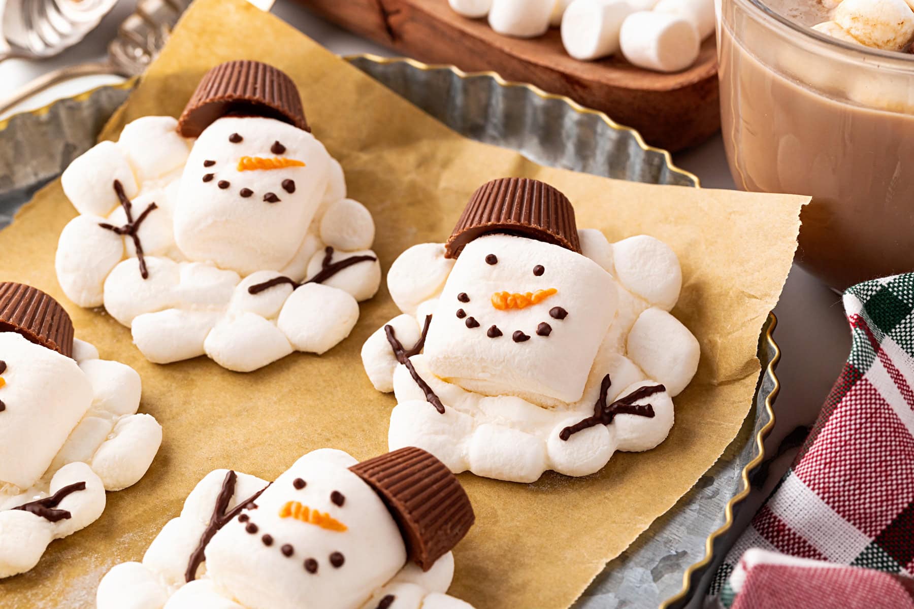 Snowmen on parchment in a tart pan. 