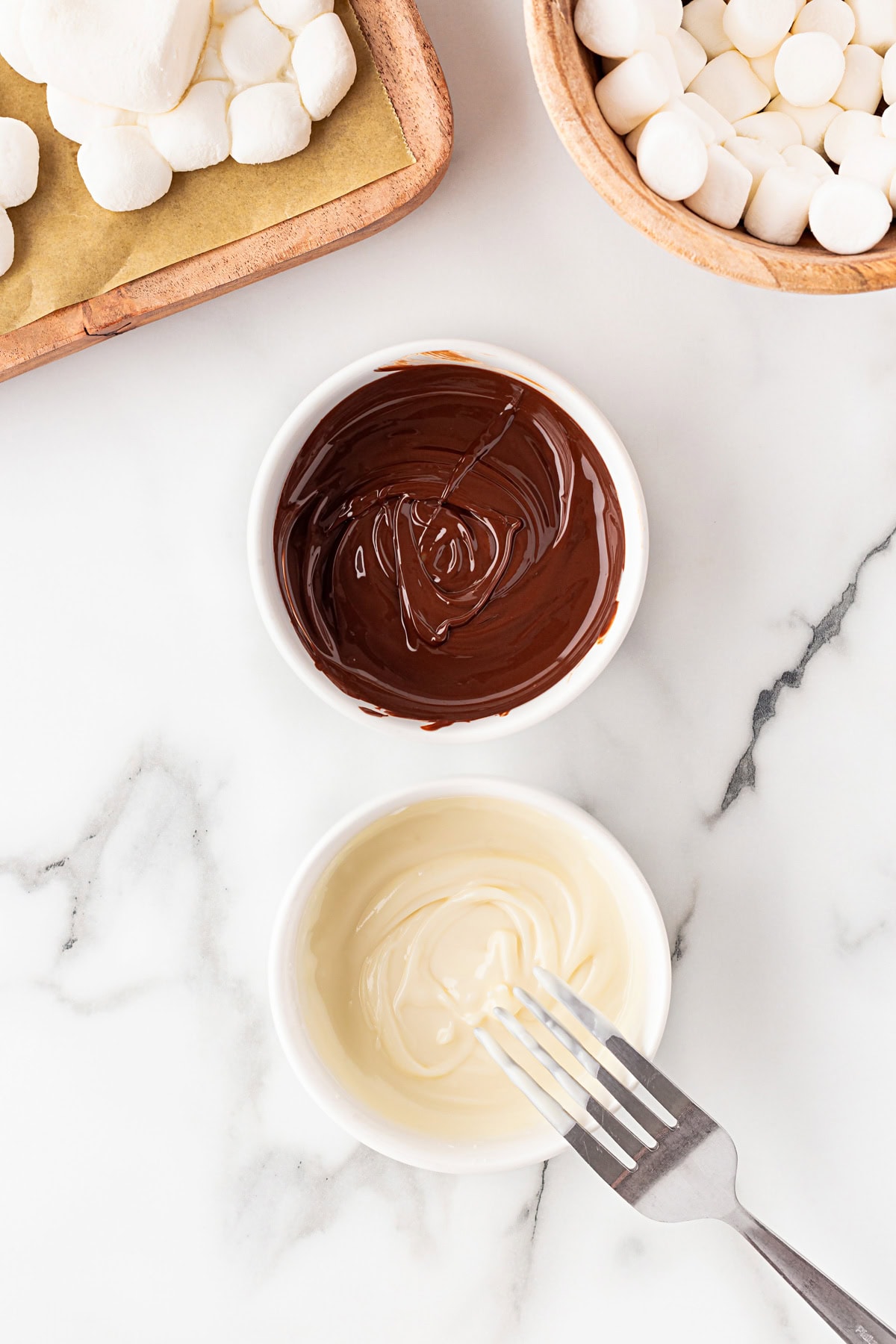 White and dark chocolate melted in bowls. 