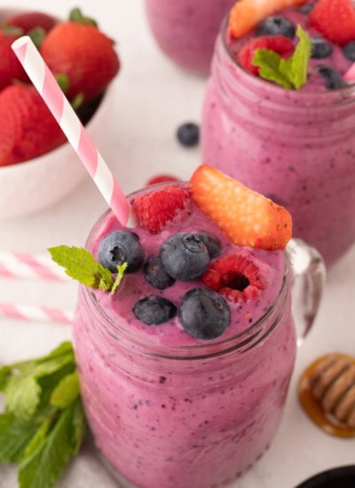 Mixed Berry Smoothie with a straw.