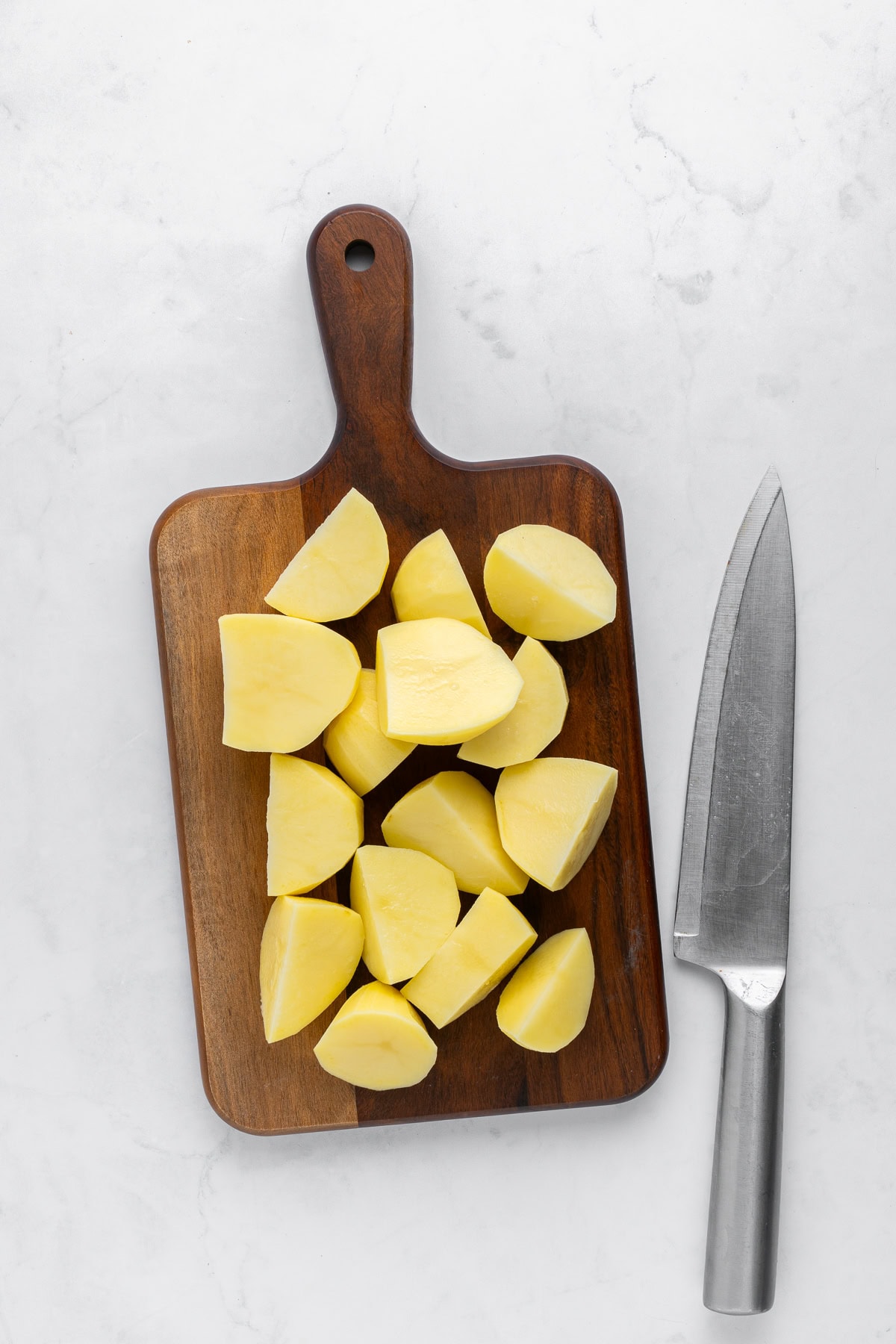 Cut potatoes on a wooden board.