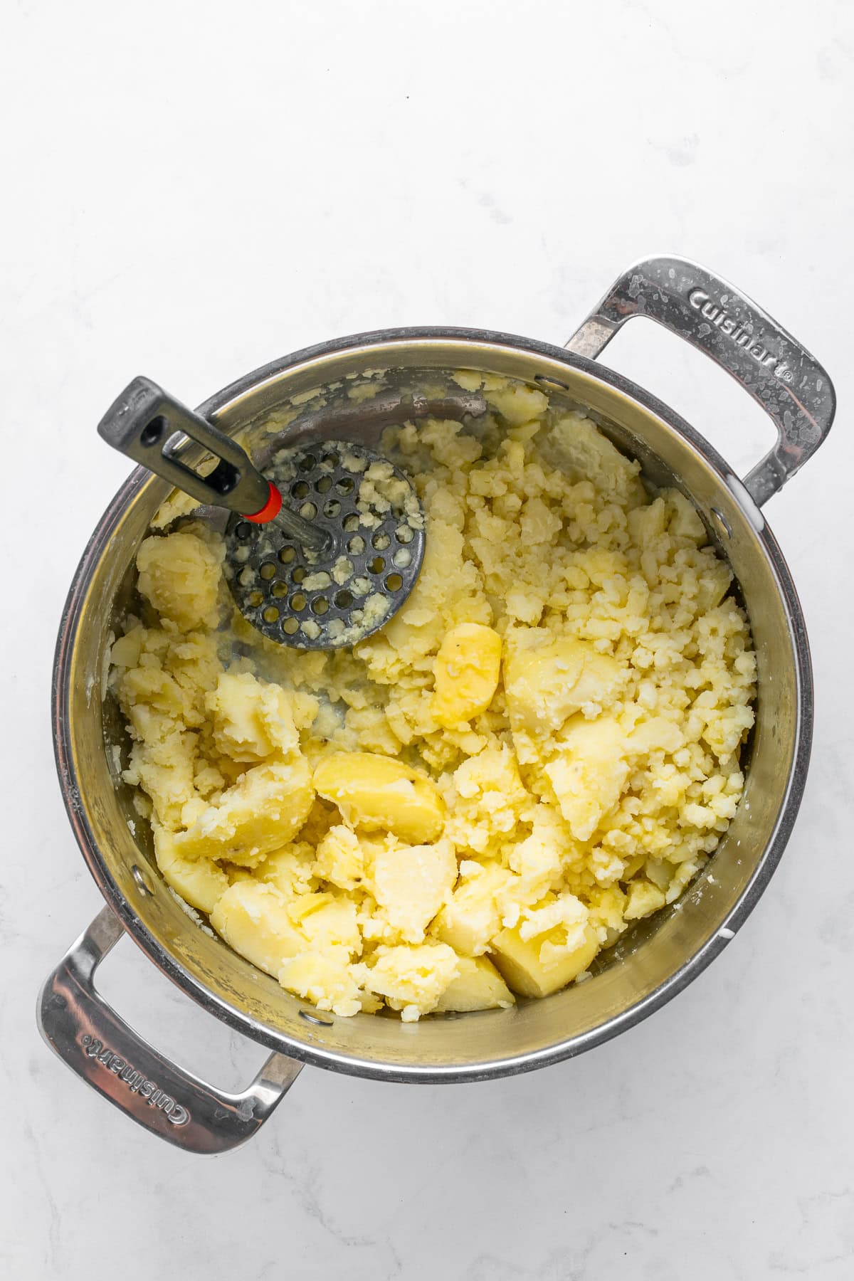 Mashing potatoes with butter.