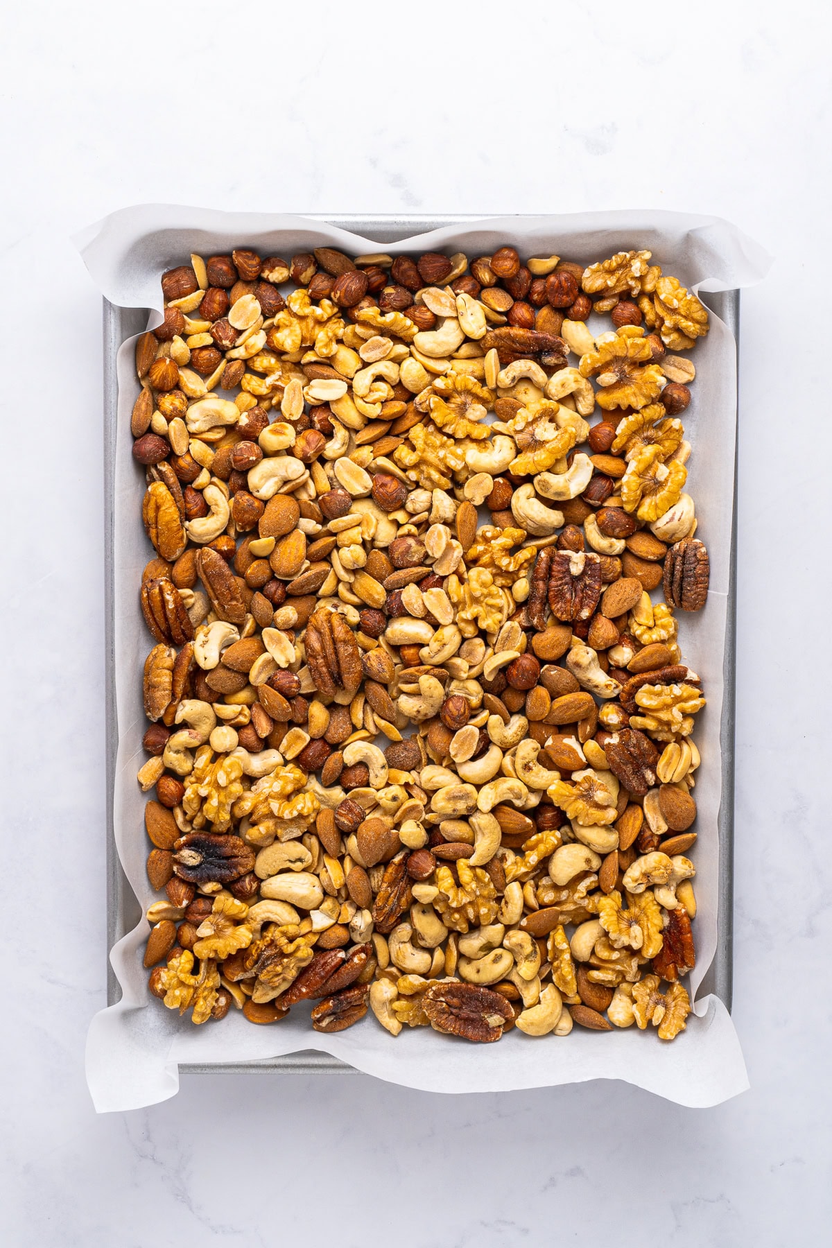 Arranging nuts on a baking sheet.