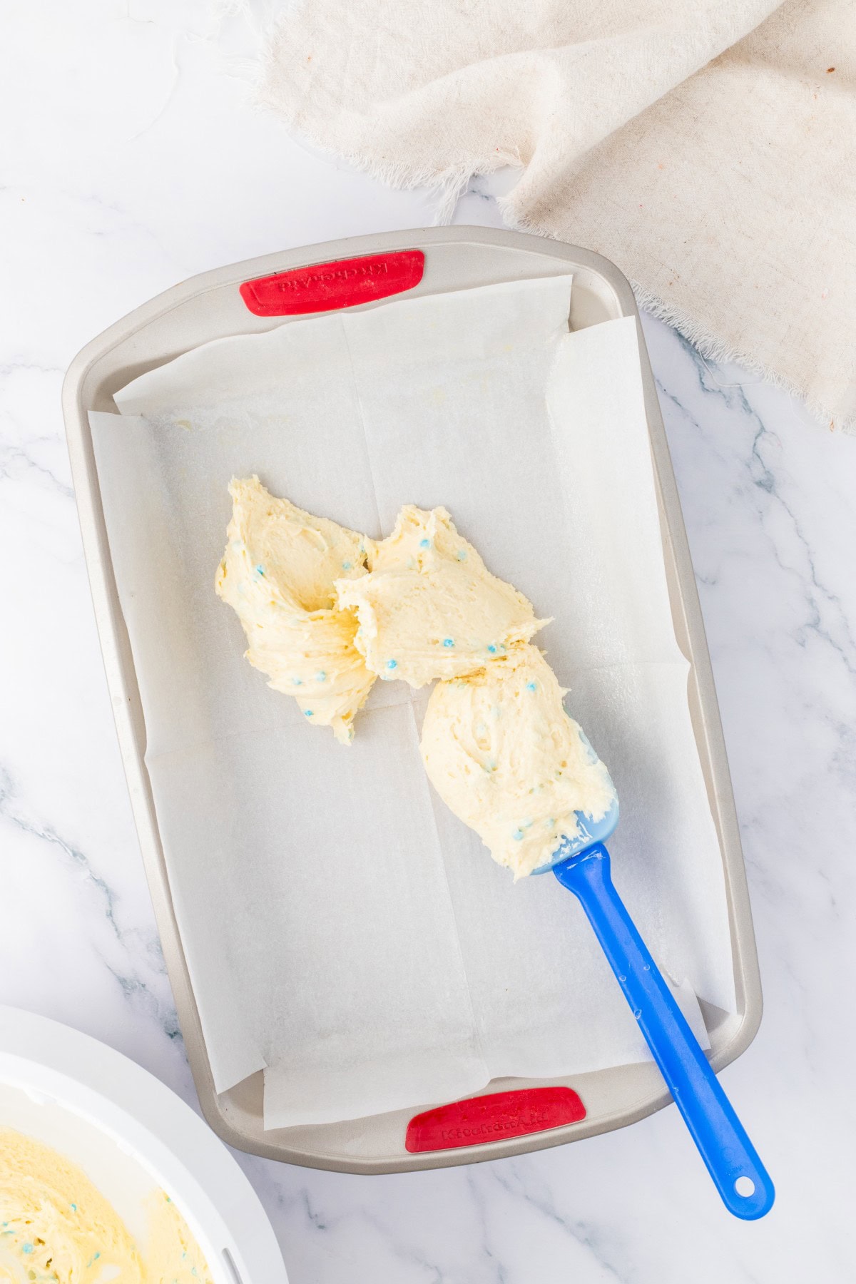 Adding batter to pan.
