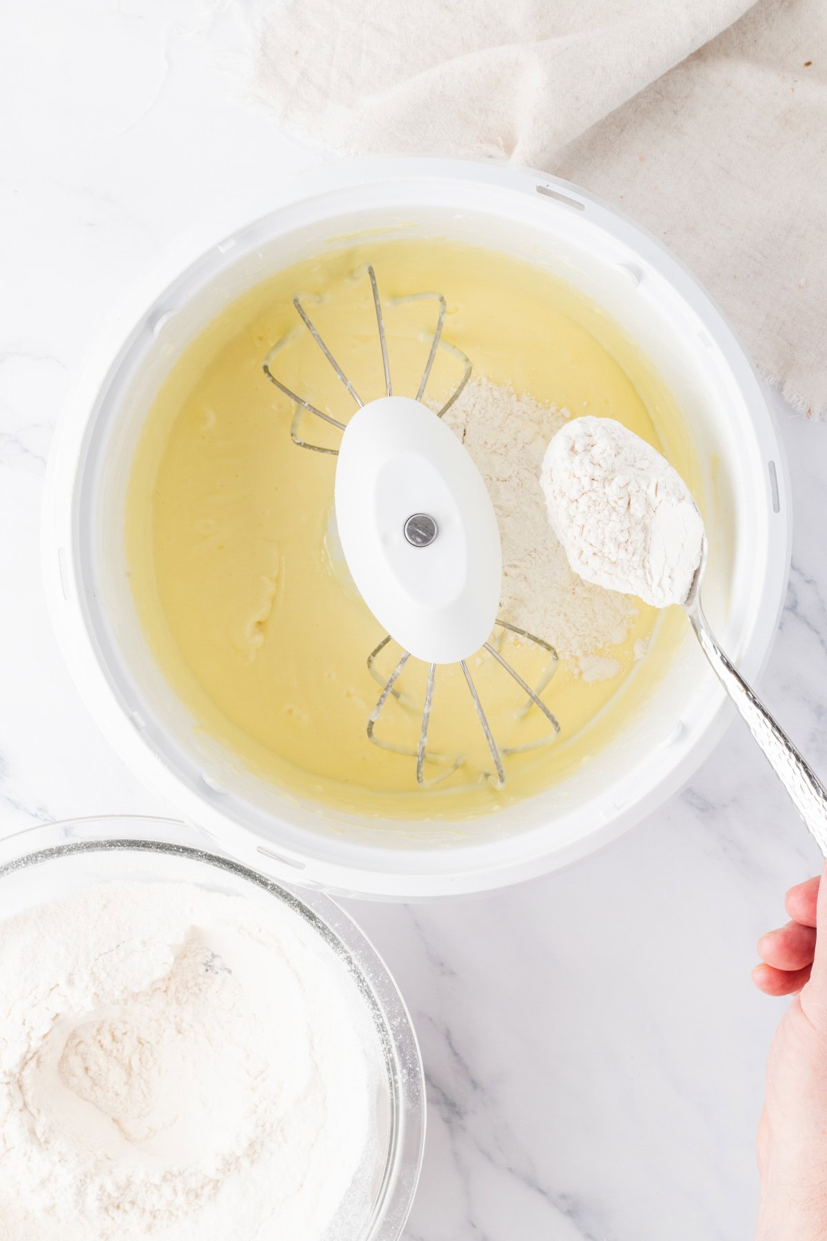 Adding flour mixture to wet.