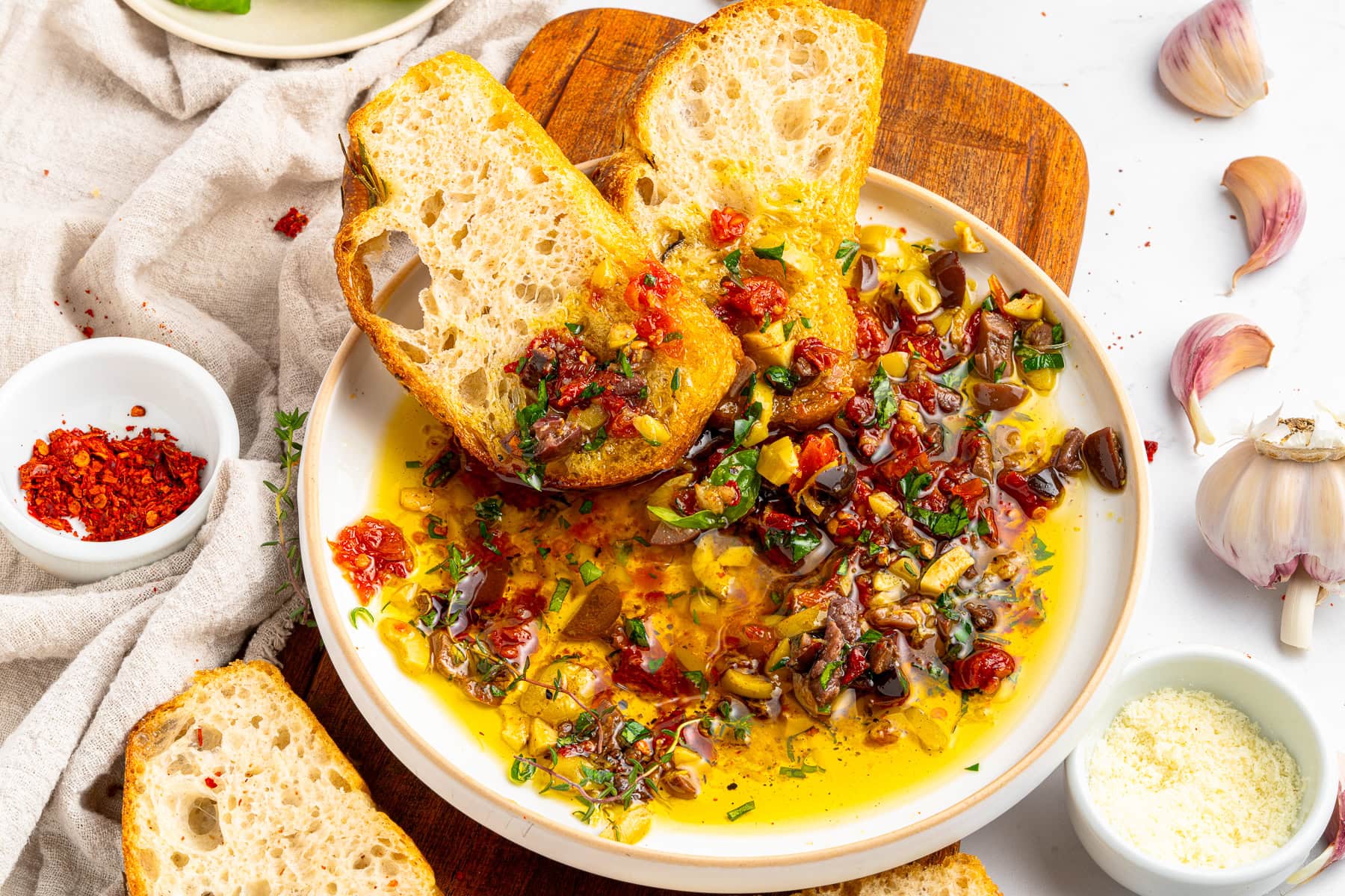 Dipping crusty bread in bread dipping oil.