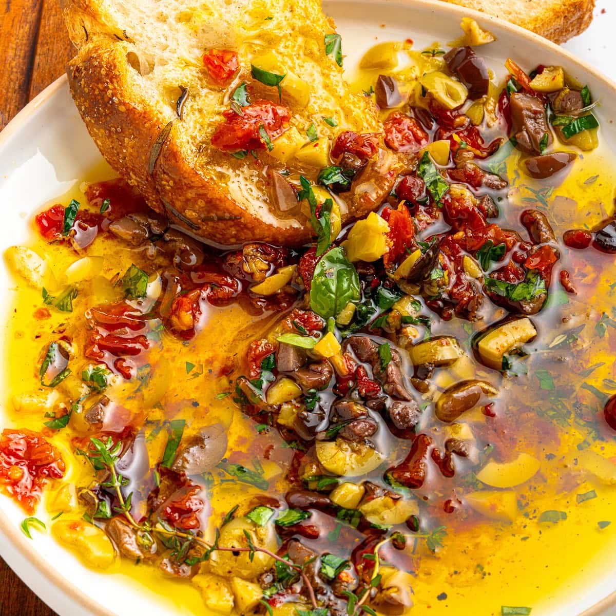 Dipping bread into seasoned oil. 
