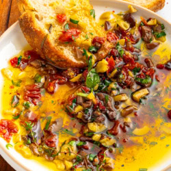 Dipping bread into seasoned oil.