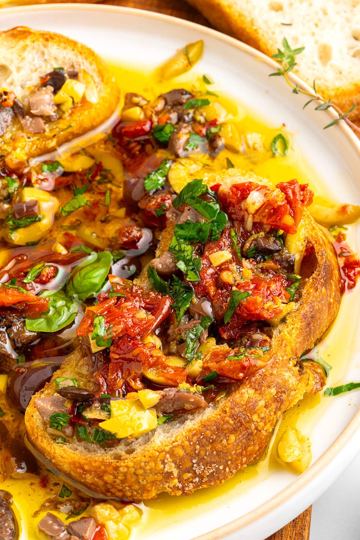 Bread fully topped with ingredients from the oil. 