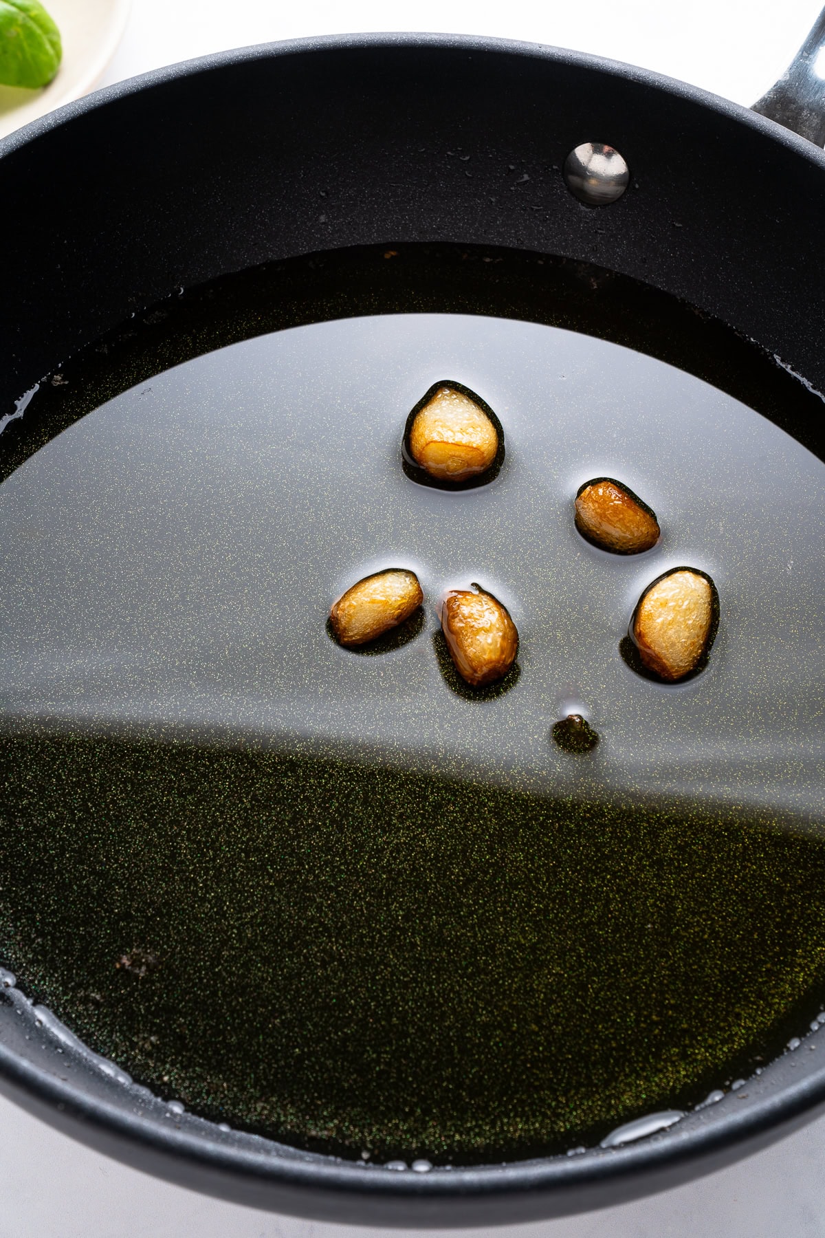 Saut&eacute;ing garlic in olive oil.