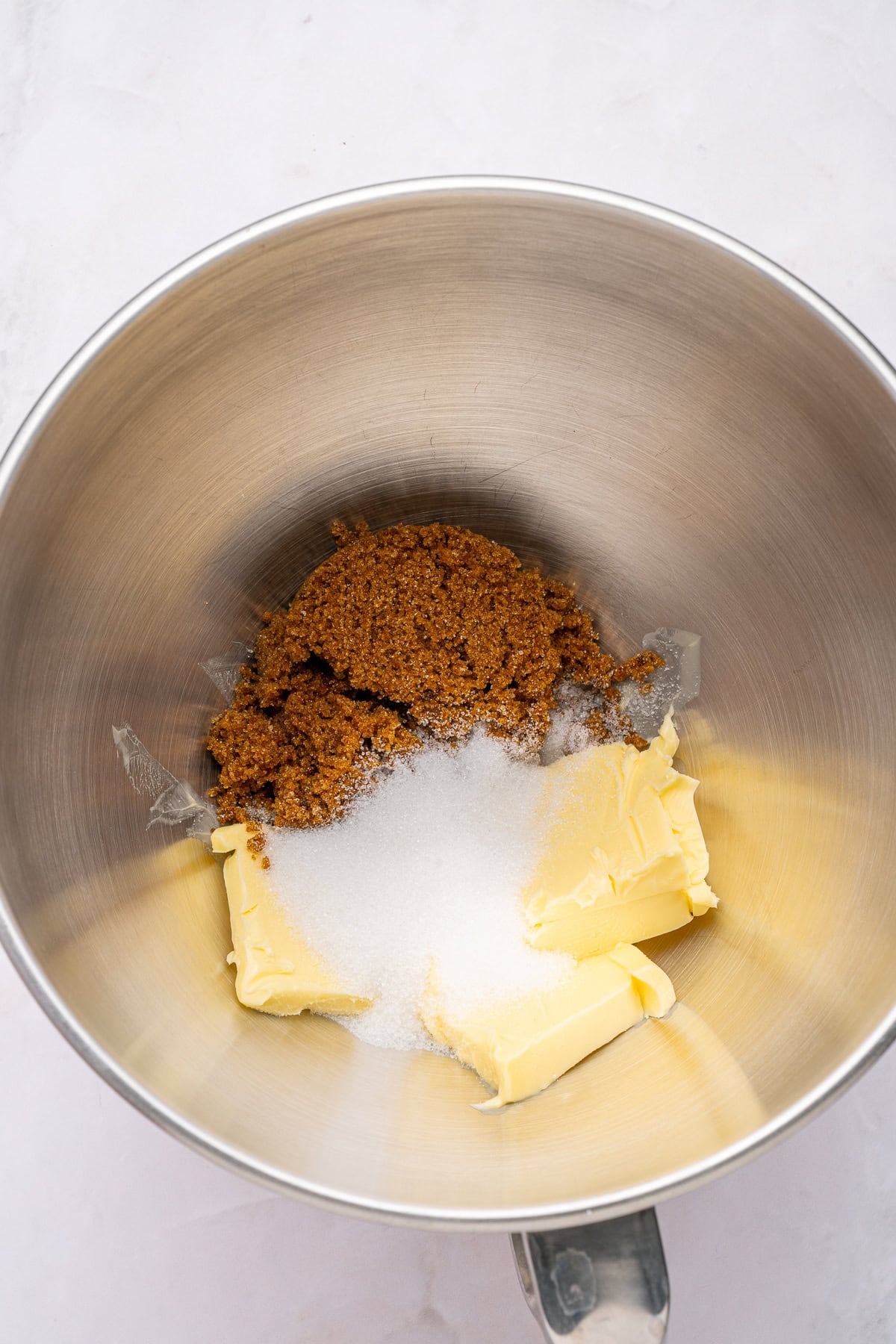 Mixing butter with sugars.