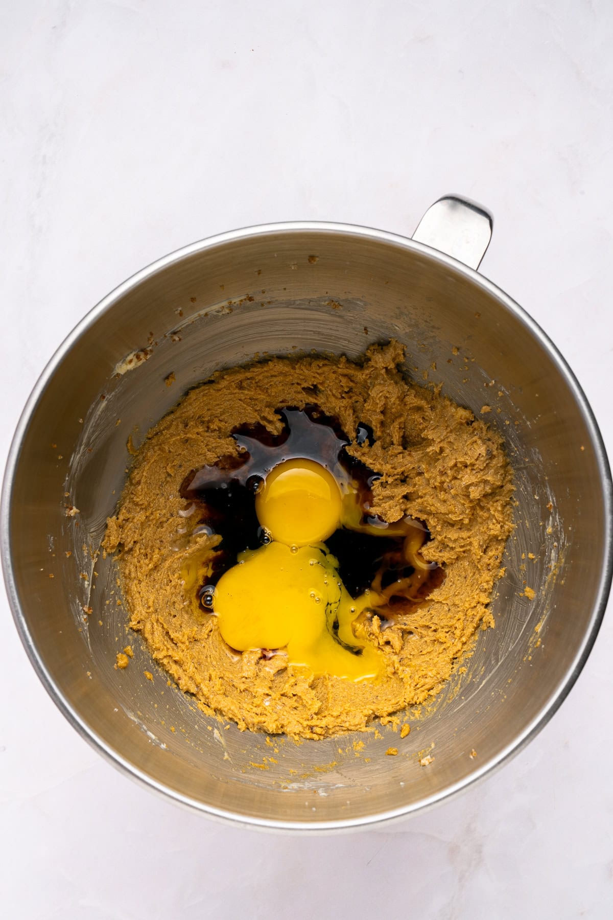 Adding the eggs, molasses and vanilla extract.