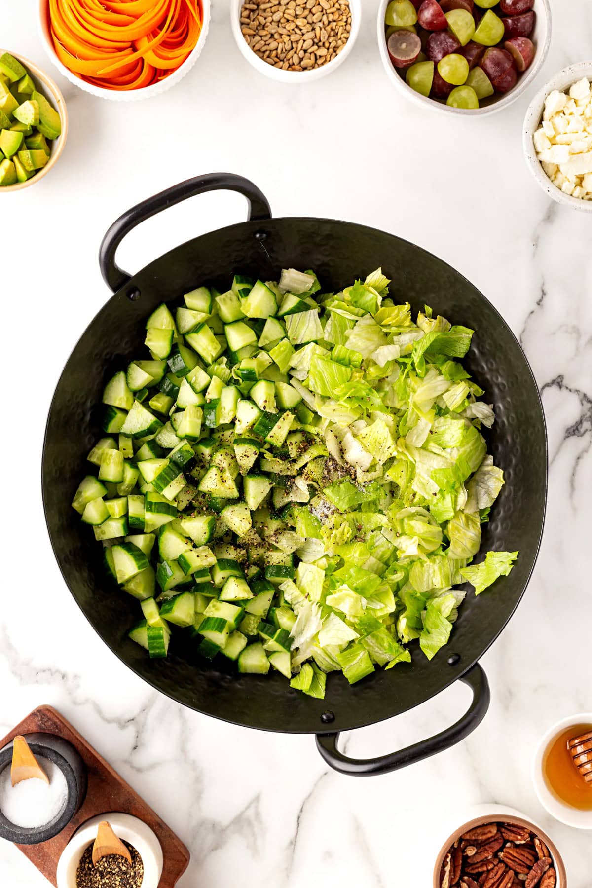 Lettuce and cucumber seasoned in bowl.