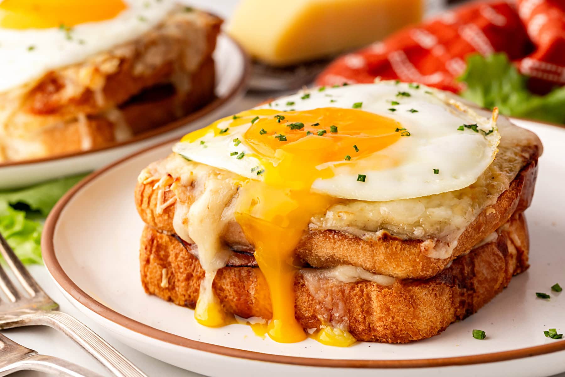 Egg dripping over the side of the sandwich. 