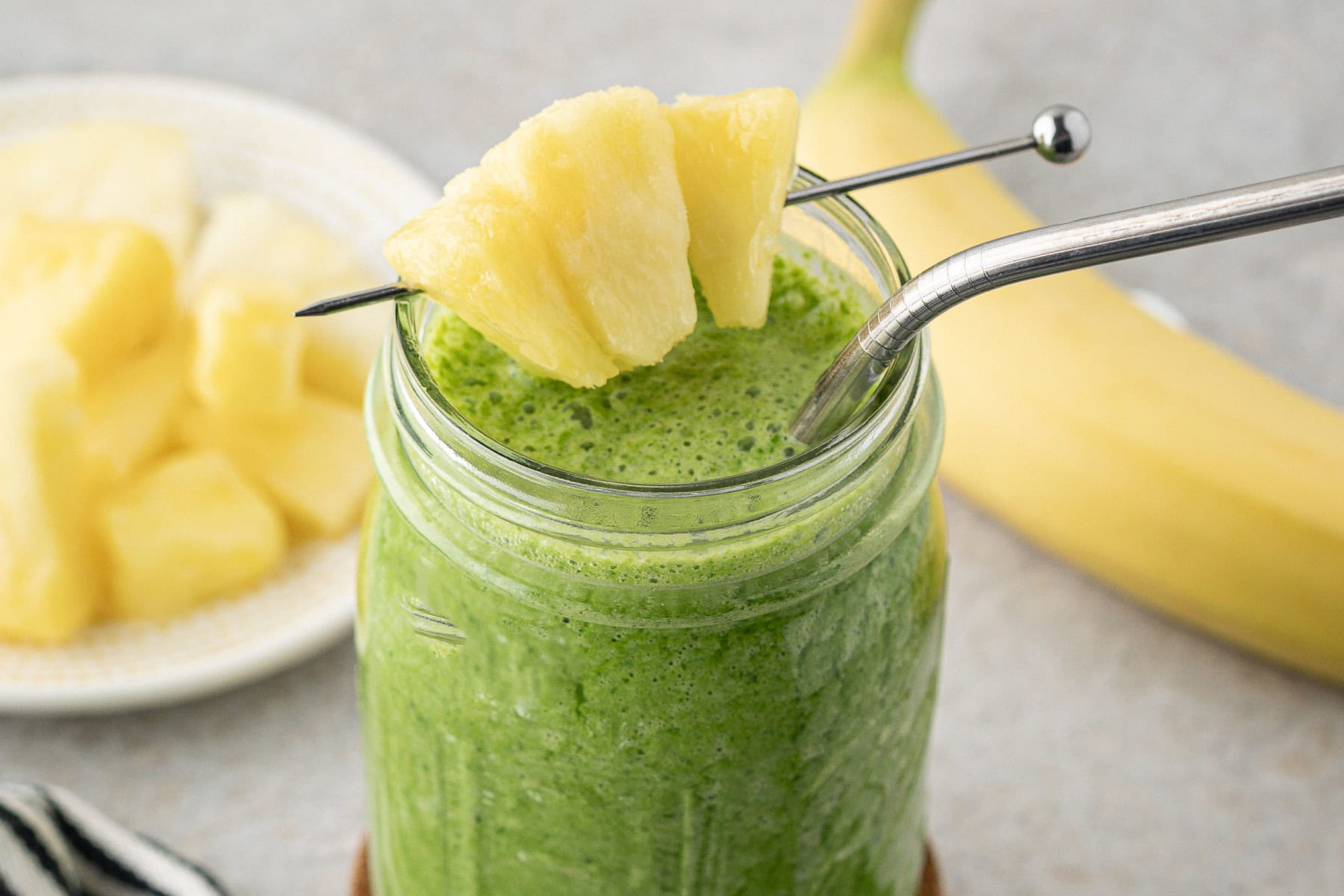Smoothie with a pineapple skewer. 