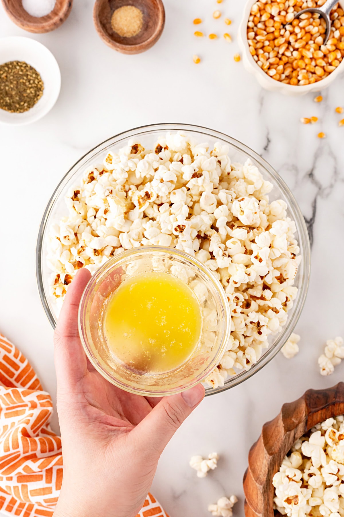 Adding butter to popcorn.