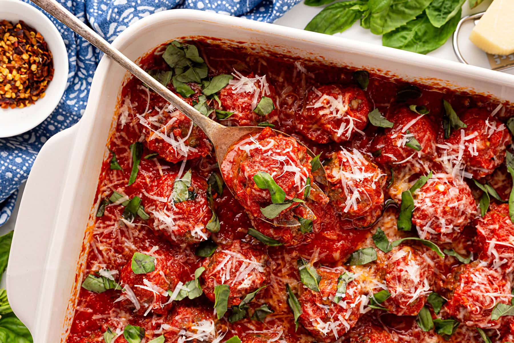 Spooning out a meatball. 