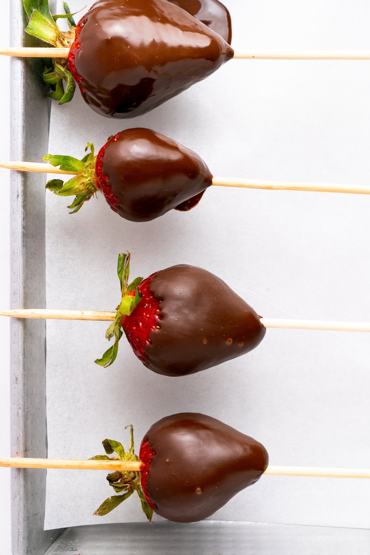 Letting chocolate covered strawberries set.