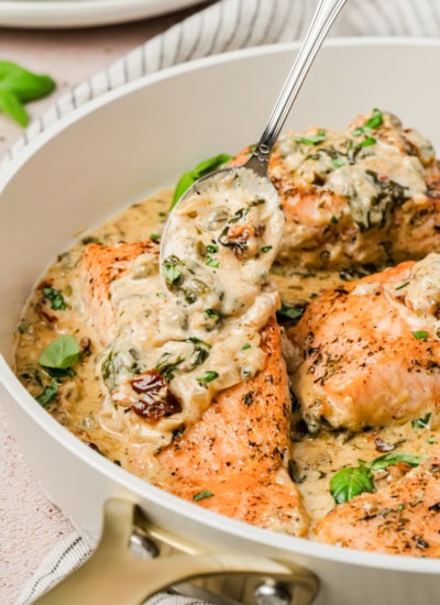 Spooning sauce over salmon.