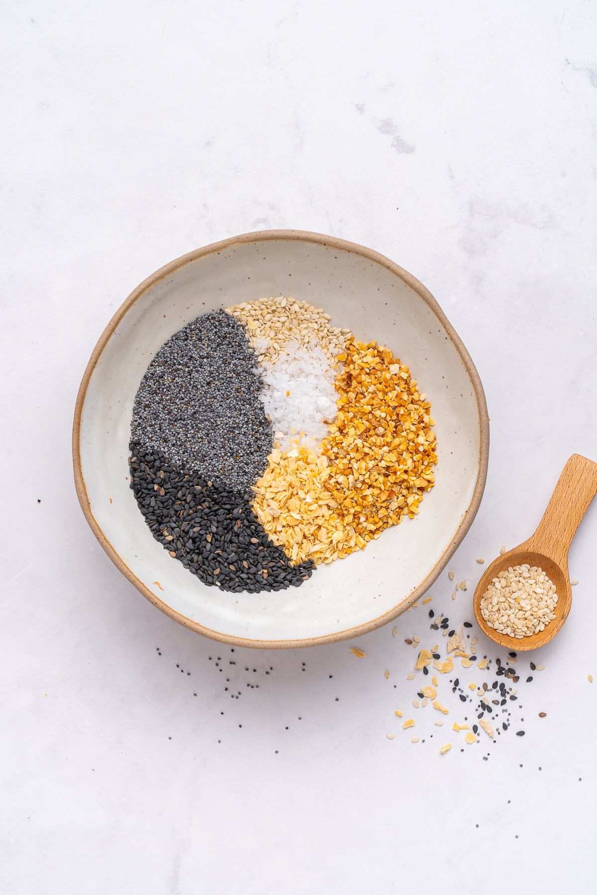 Mixing everything bagel seasoning ingredients.