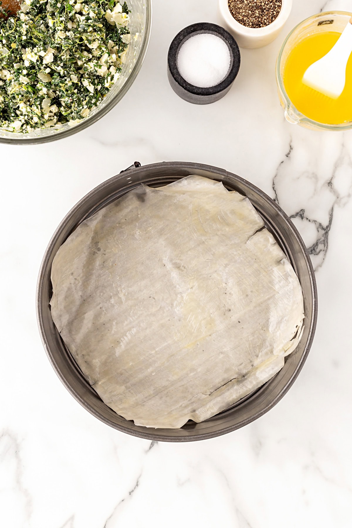 Adding phyllo to springform. 