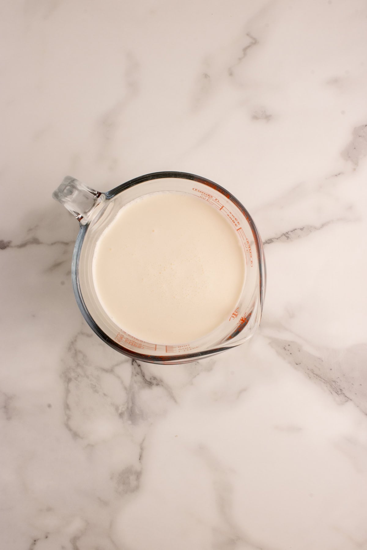 Cream in a measuring cup. 